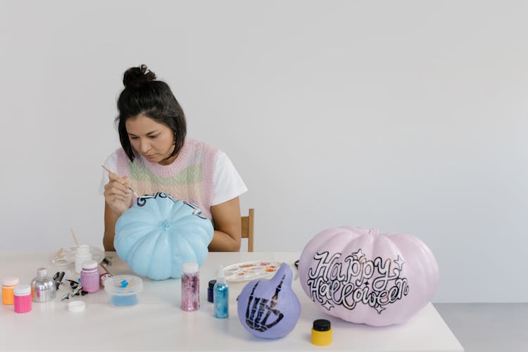 Woman Painting The Blue Pumpkin 