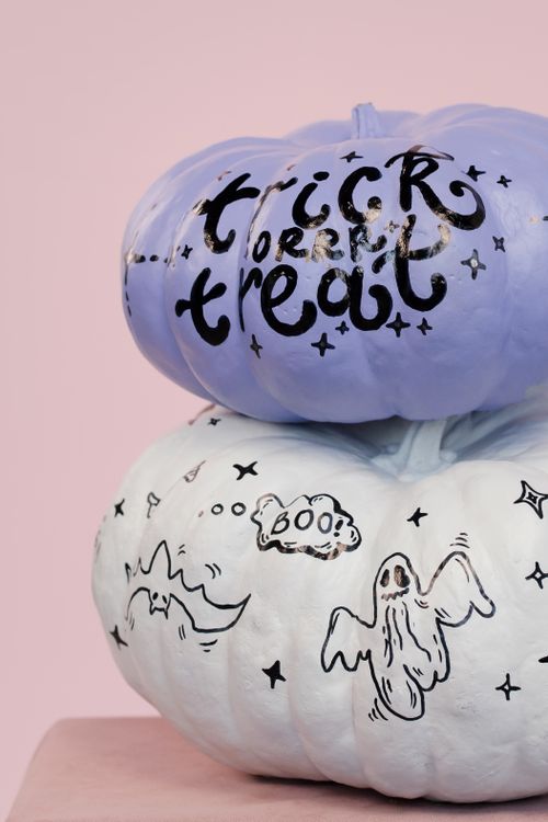 Free Decorative pumpkins painted for Halloween featuring 'Trick or Treat' and spooky designs. Stock Photo