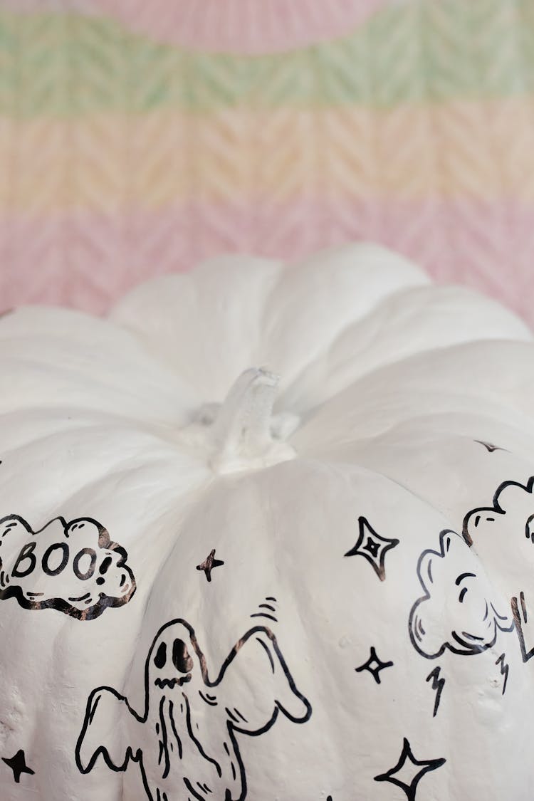 Close-up Photo Of White Pumpkin With Scary Drawings