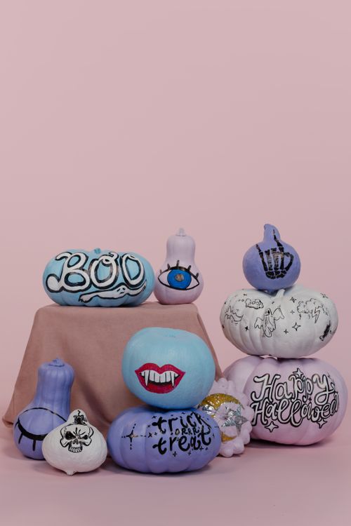 Free Colorful painted pumpkins with Halloween themes against a pink backdrop. Stock Photo