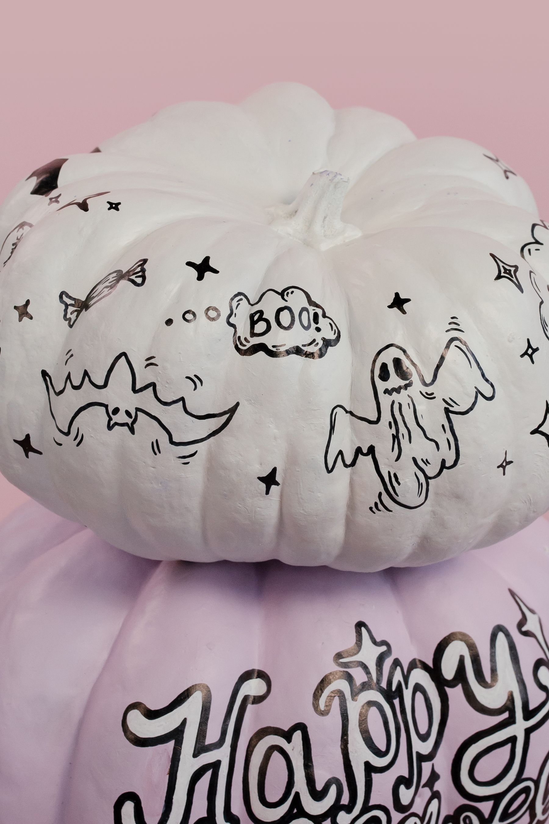 Small Halloween pumpkins painted with themed motifs