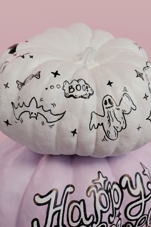 Free Decorative Halloween pumpkins with ghost and bat artwork for a festive touch. Stock Photo