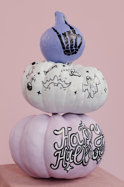 Stacks of Halloween Pumpkins on Pink Background