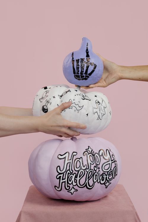 Free Handmade Halloween pumpkins with unique designs in a creative stacking composition. Stock Photo