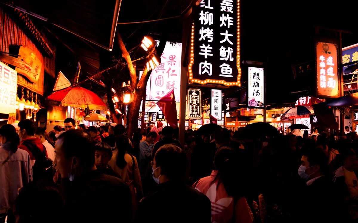 Bustling street market stalls in Xi'an, China, the kind of place where many of the food and attraction prices in this guide were checked