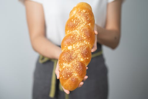 Close-Up Shot of a Person Holding a Delicious Bread