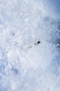 Captivating close-up of frozen bubbles in ice from Grundarfjörður, Iceland.