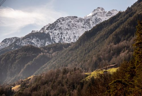 Free Stunning Swiss mountain scenery with snowcapped peaks and lush forests in an idyllic setting. Stock Photo