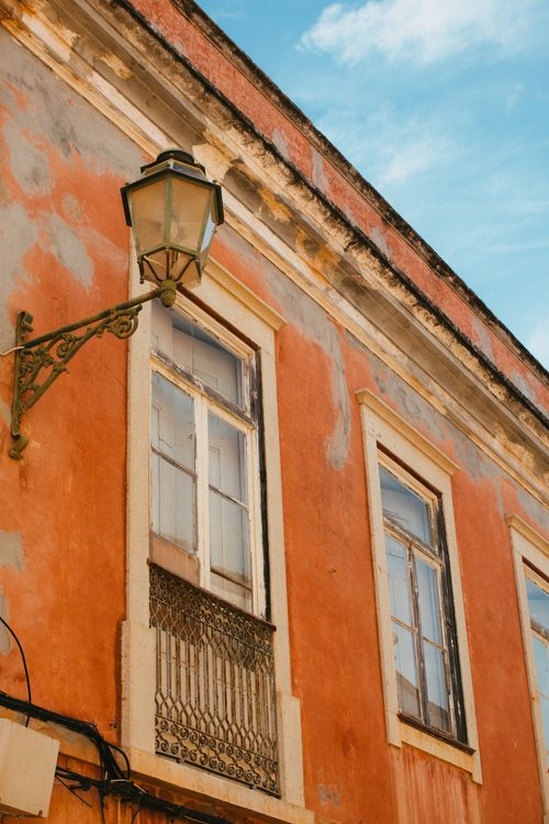 Free Vibrant warm-toned building facade with rustic charm in Lagos, Portugal, captured on a sunny day. Stock Photo