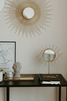 Stylish workspace featuring artistic decor, mirrors, and a planner for a productive home office setting.