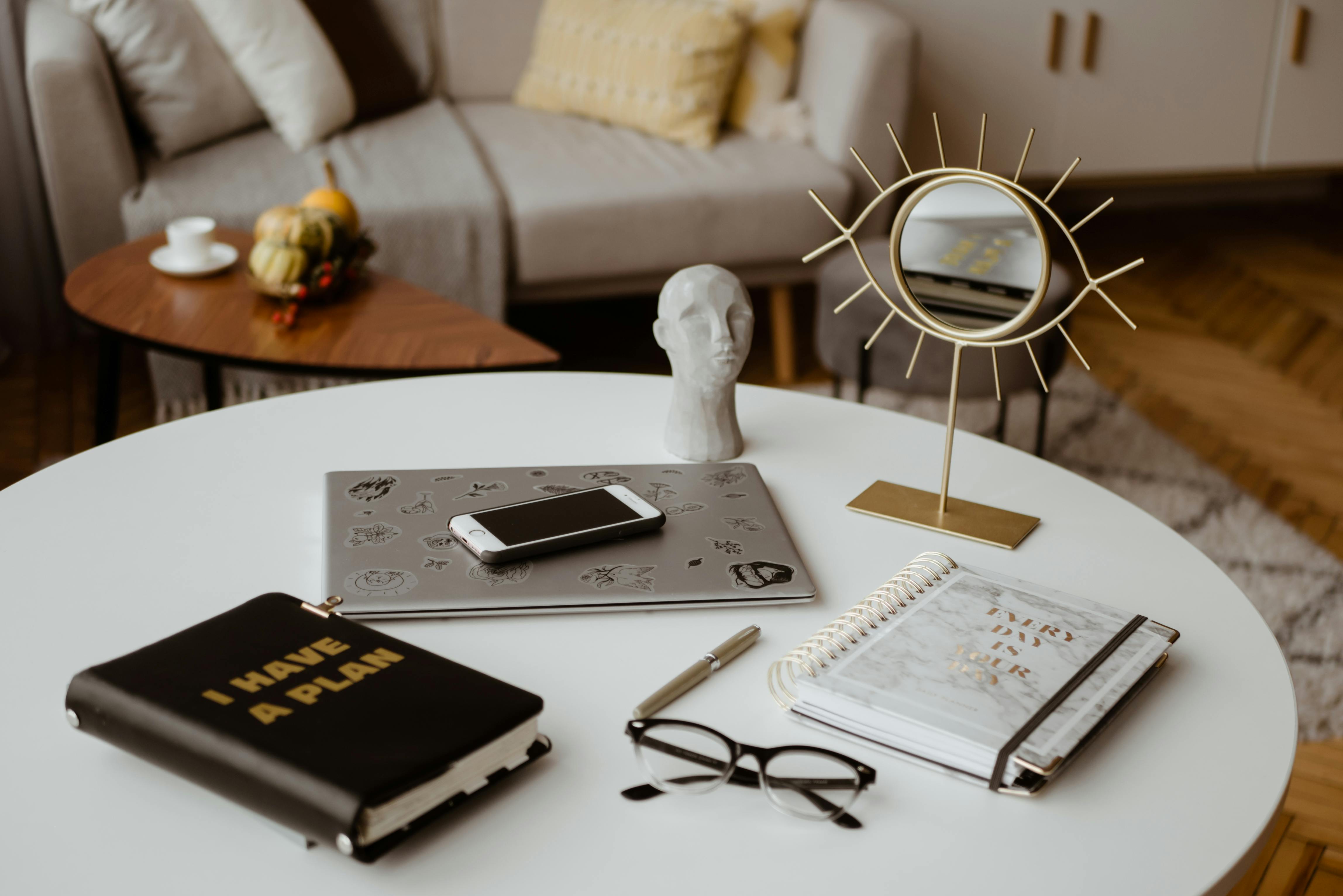 black framed eyeglasses on white notebook