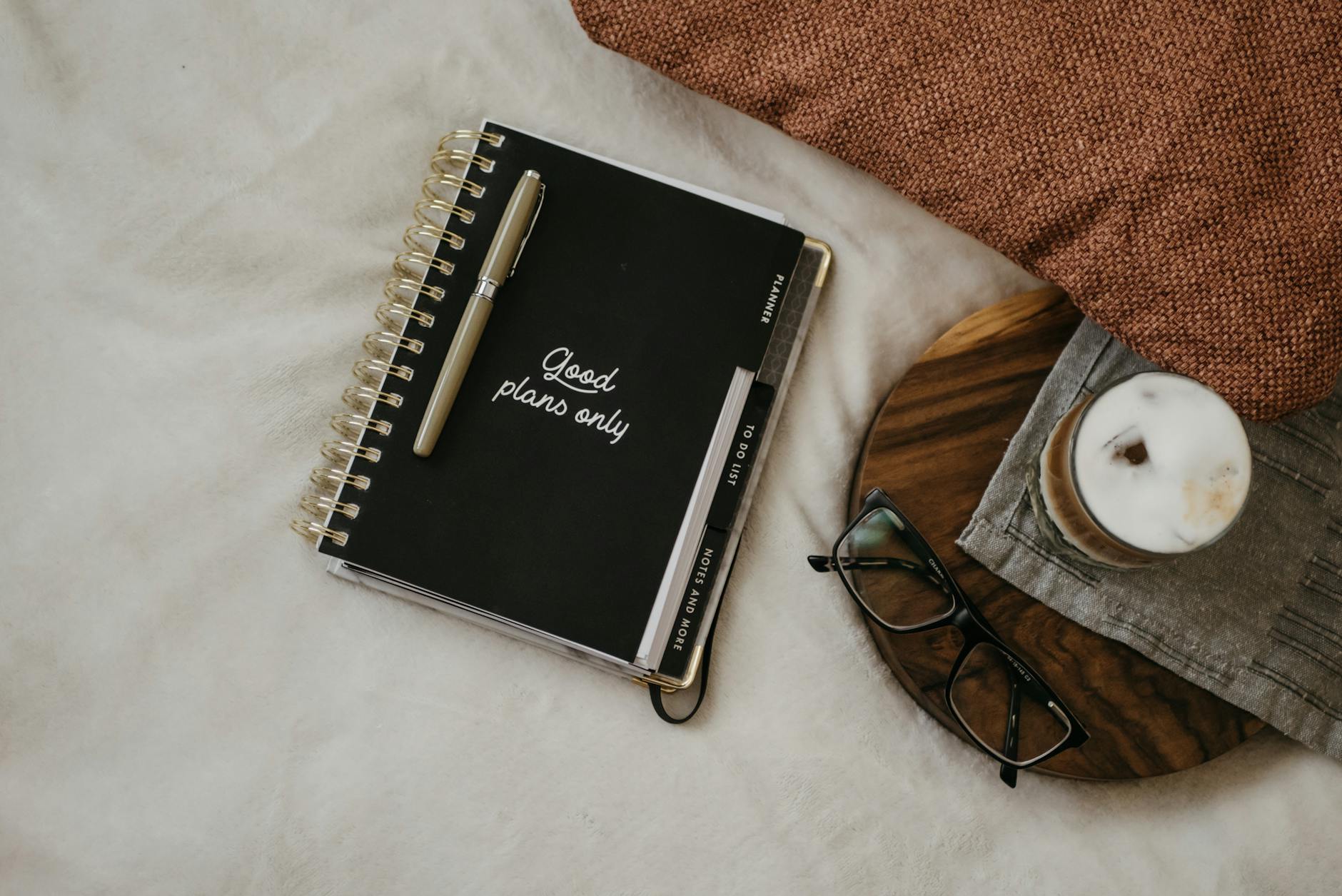 Black Eye Glasses Beside Black Notebook