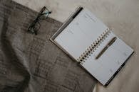 A Planner with Pen on the Bed