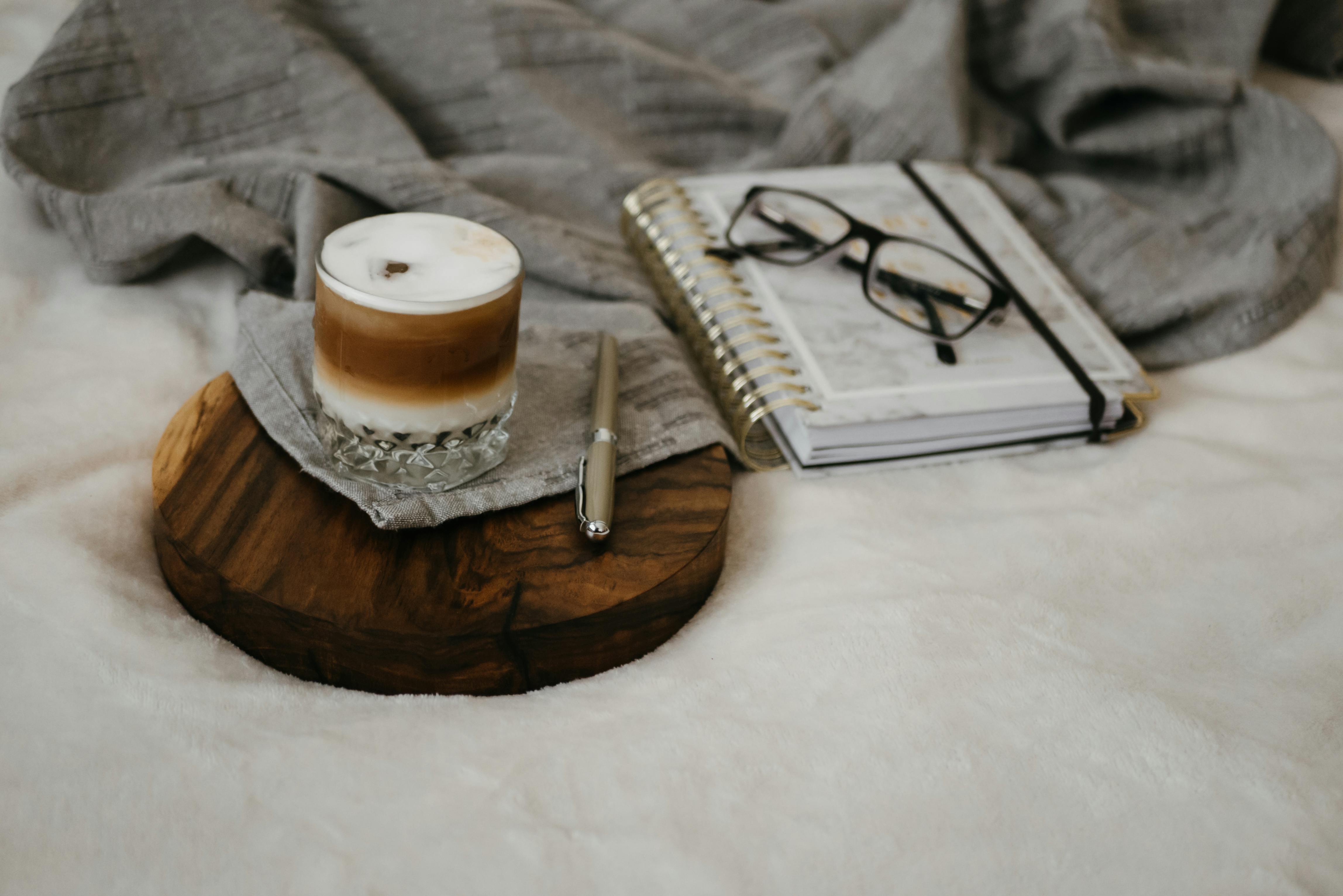 A Coffee and Pen on the Wooden Tray