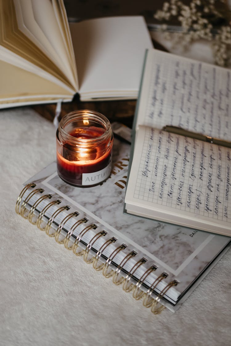 A Diary Beside A Lit Candle