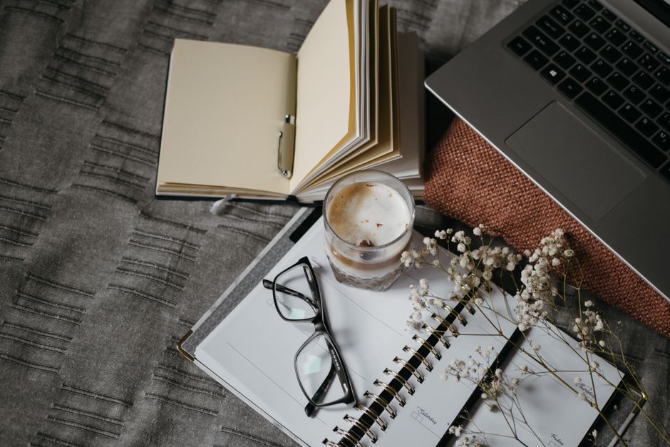 planner beside laptop natural light lifestyle photo 1