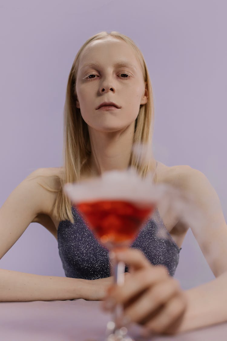 A Woman Holding A Cocktail