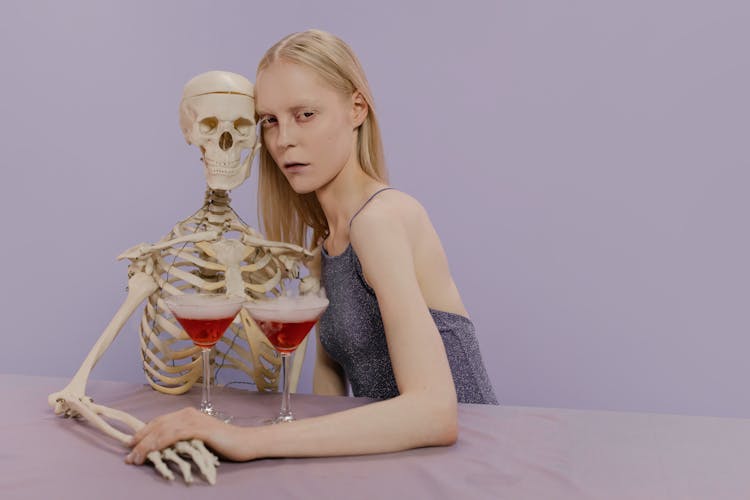 A Woman Sitting With Skeleton