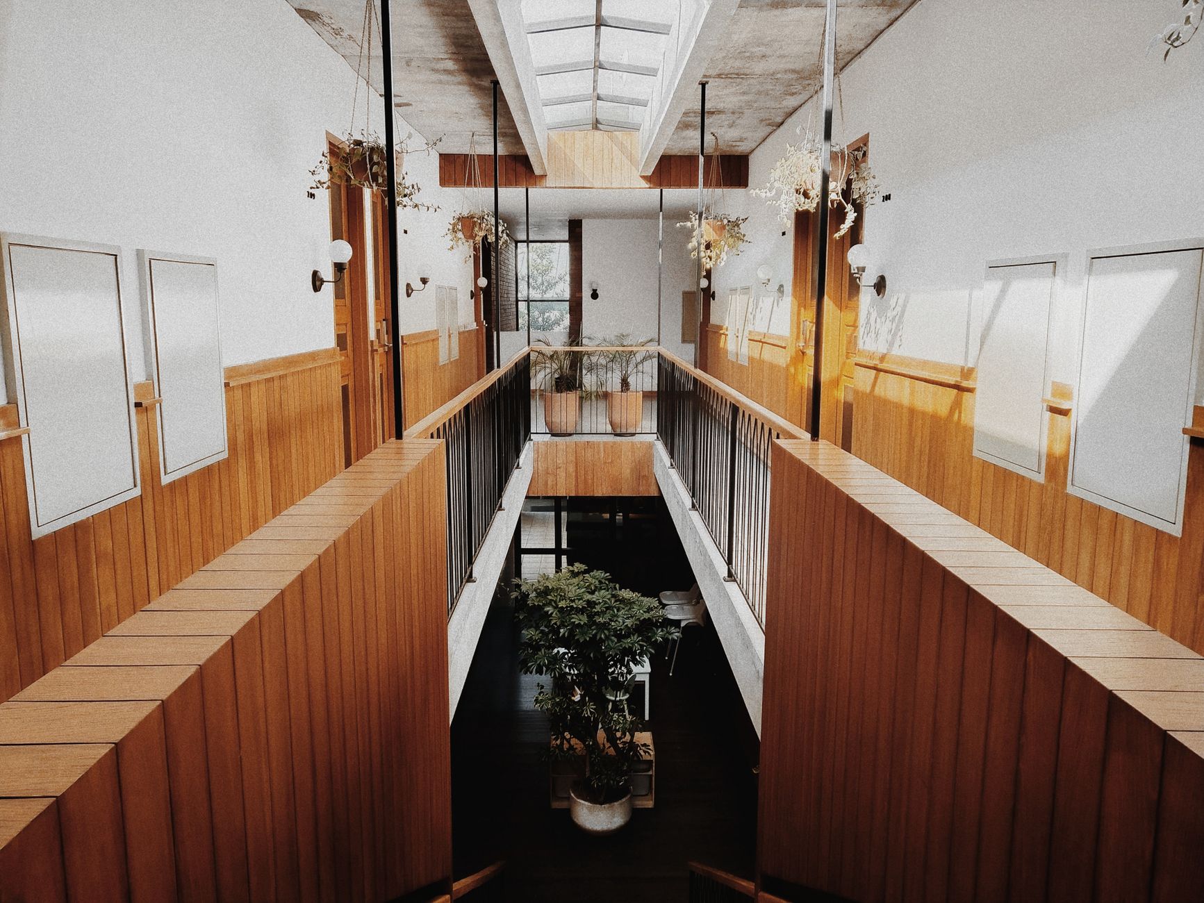 Modern office interior featuring a wooden staircase and symmetrical design elements.