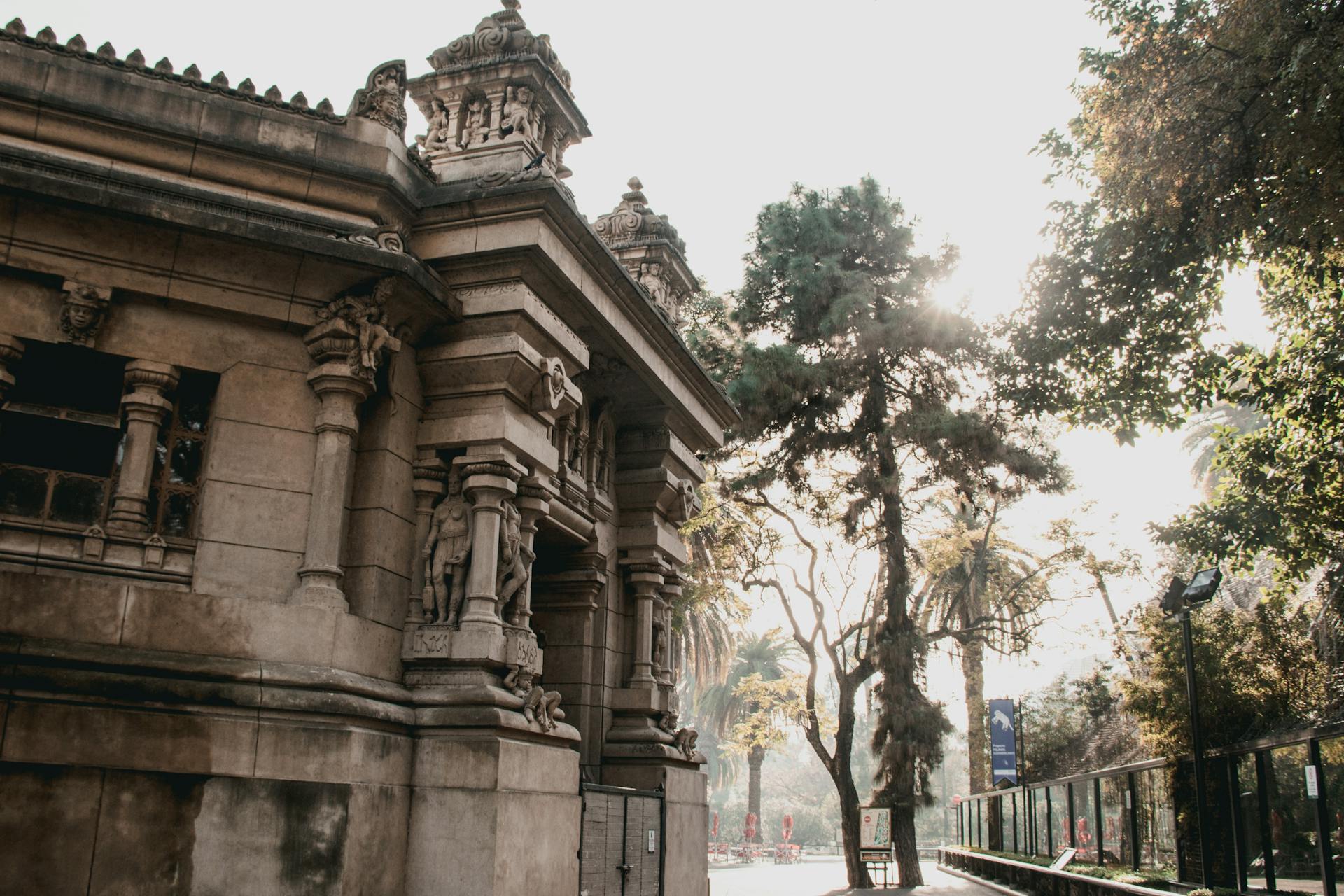 Elegant historic building with sculptures in a sunlit Buenos Aires park.