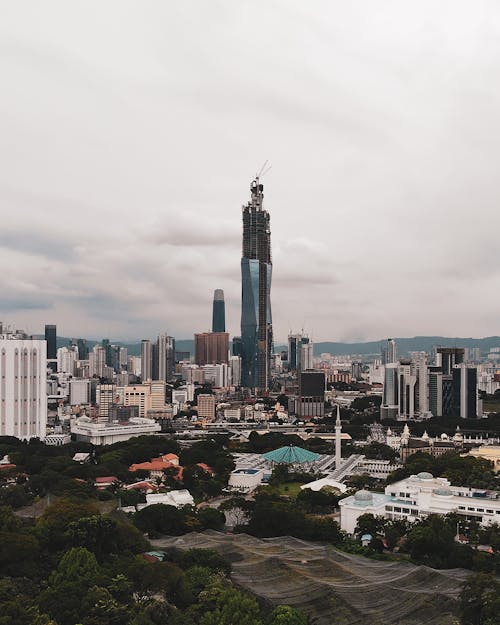 Free The Merdeka Tower Amidst City Buildings in Kuala Lumpur, Malaysia Stock Photo
