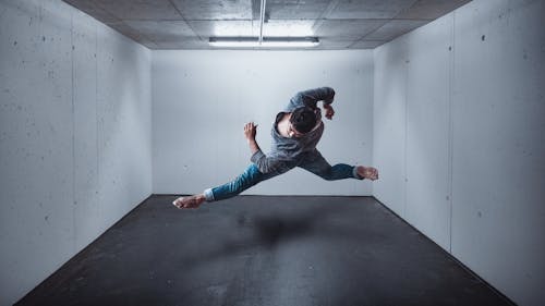 Free Man in Gray Hoodie and Blue Denim Jeans Dancing Stock Photo