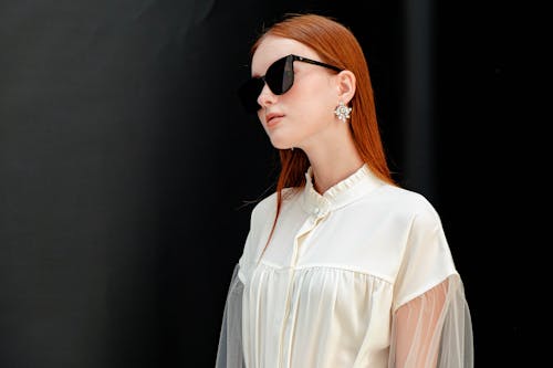 Free 
A Woman Wearing Sunglasses and a White Top Stock Photo