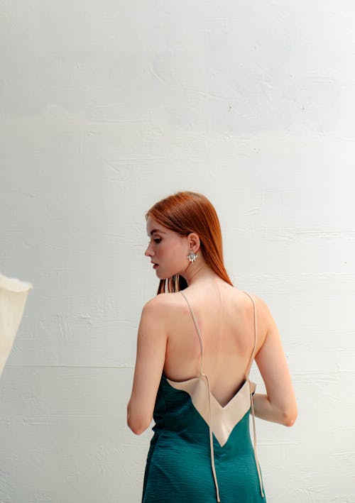 Back View of a Woman with Red Hair Wearing a Dress