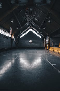 A dimly lit, empty basketball court with modern architecture in Chicago.