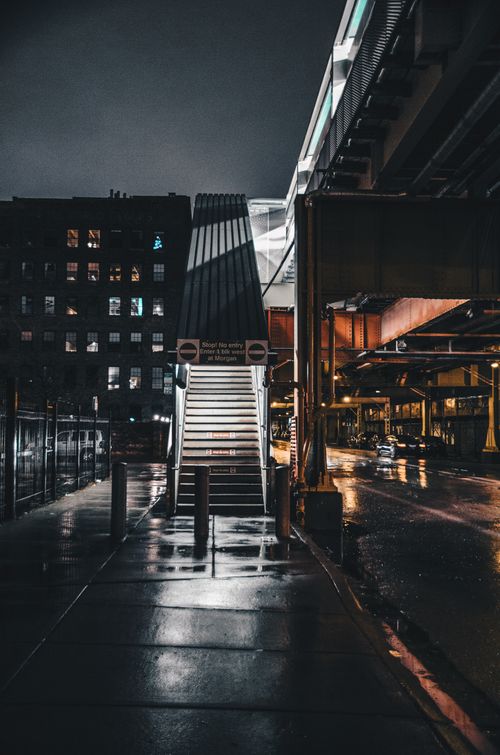 Free Dramatic night view of Chicago's urban architecture, highlighting a dimly lit overpass and stairs. Stock Photo