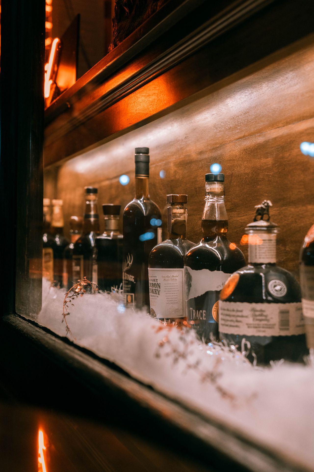 Elegant display of whiskey bottles in a dimly lit cabinet