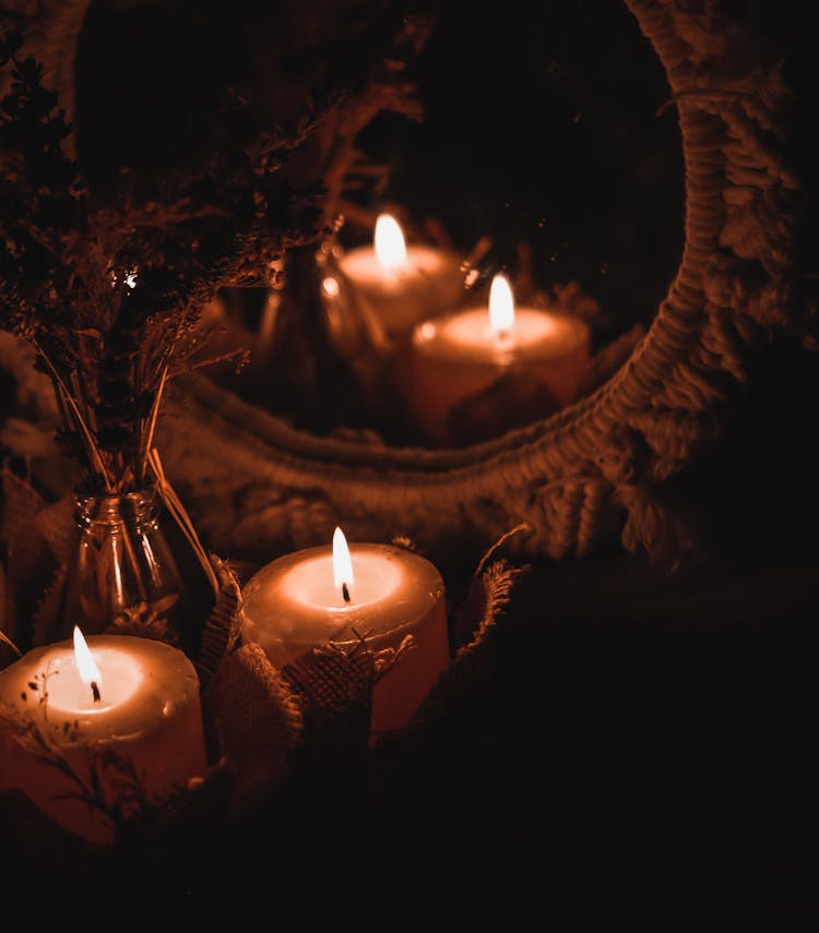 Lighted Candles In Front Of A Mirror