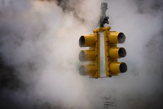 A moody capture of traffic lights surrounded by mist in New York City.