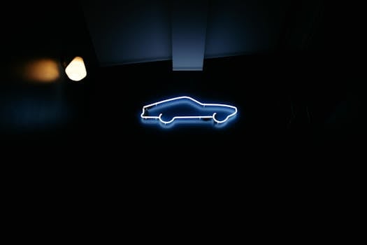 A glowing blue neon car silhouette mounted on a dark wall, minimalist style.