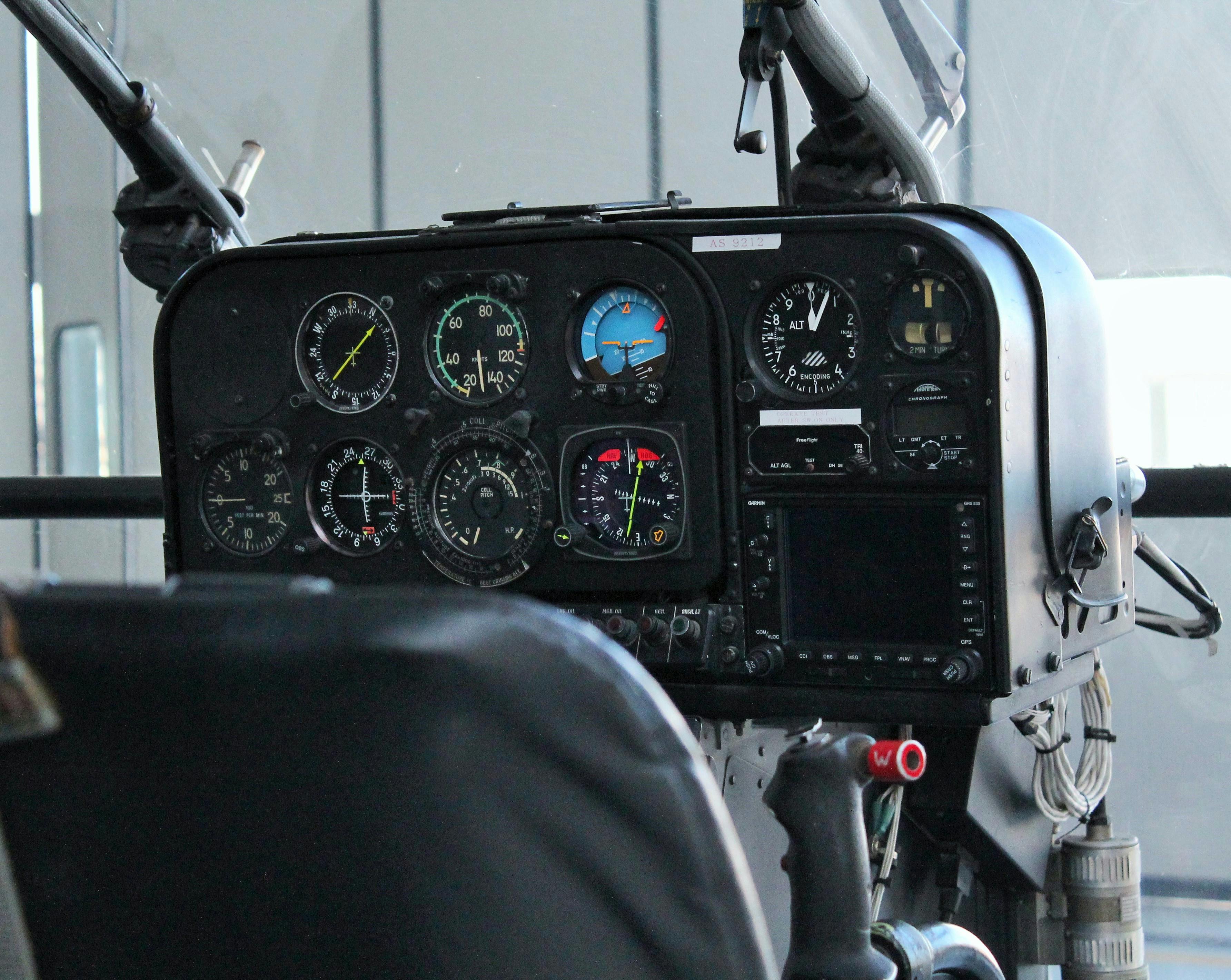 Detailed view of aircraft cockpit showing instrument panel and controls.