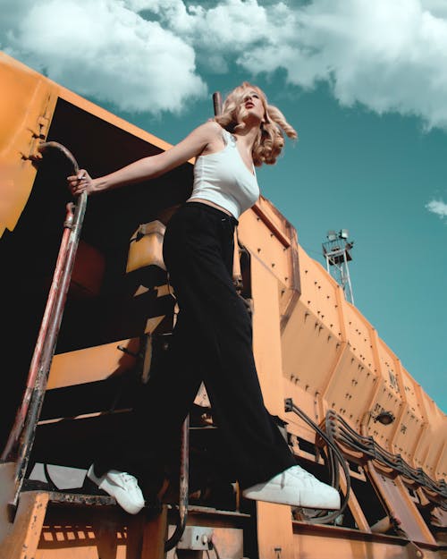 A Woman in White Tank Top and Black Pants