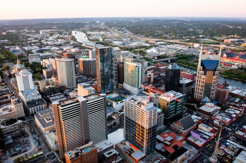 Free Stunning aerial cityscape of Nashville, Tennessee featuring skyscrapers and urban layout at sunset. Stock Photo