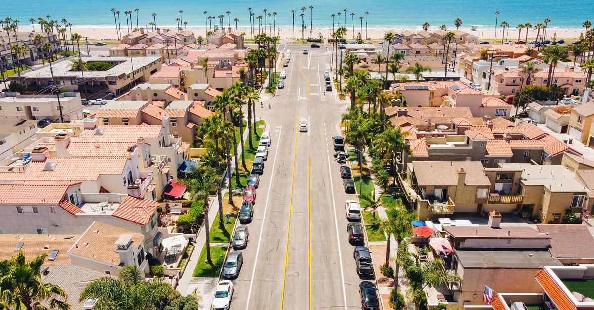 Explore Huntington Beach's beautiful neighborhood and coastline in this vibrant aerial shot.