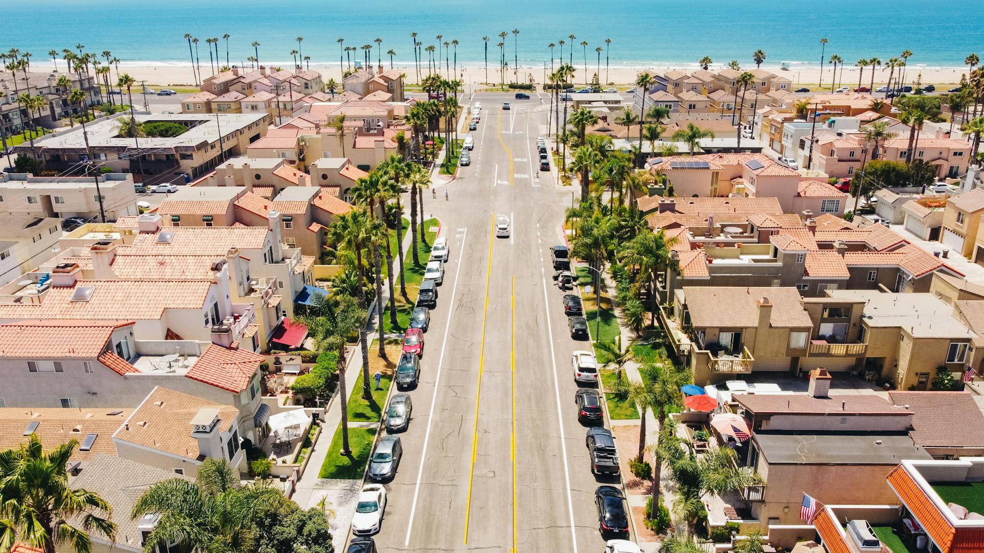 Explore Huntington Beach's beautiful neighborhood and coastline in this vibrant aerial shot.