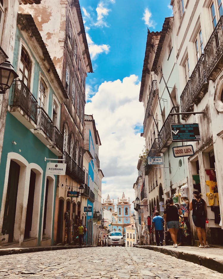 A Narrow Street With A Blue Church At The End In Pelourinho, Salvador, Brazil 