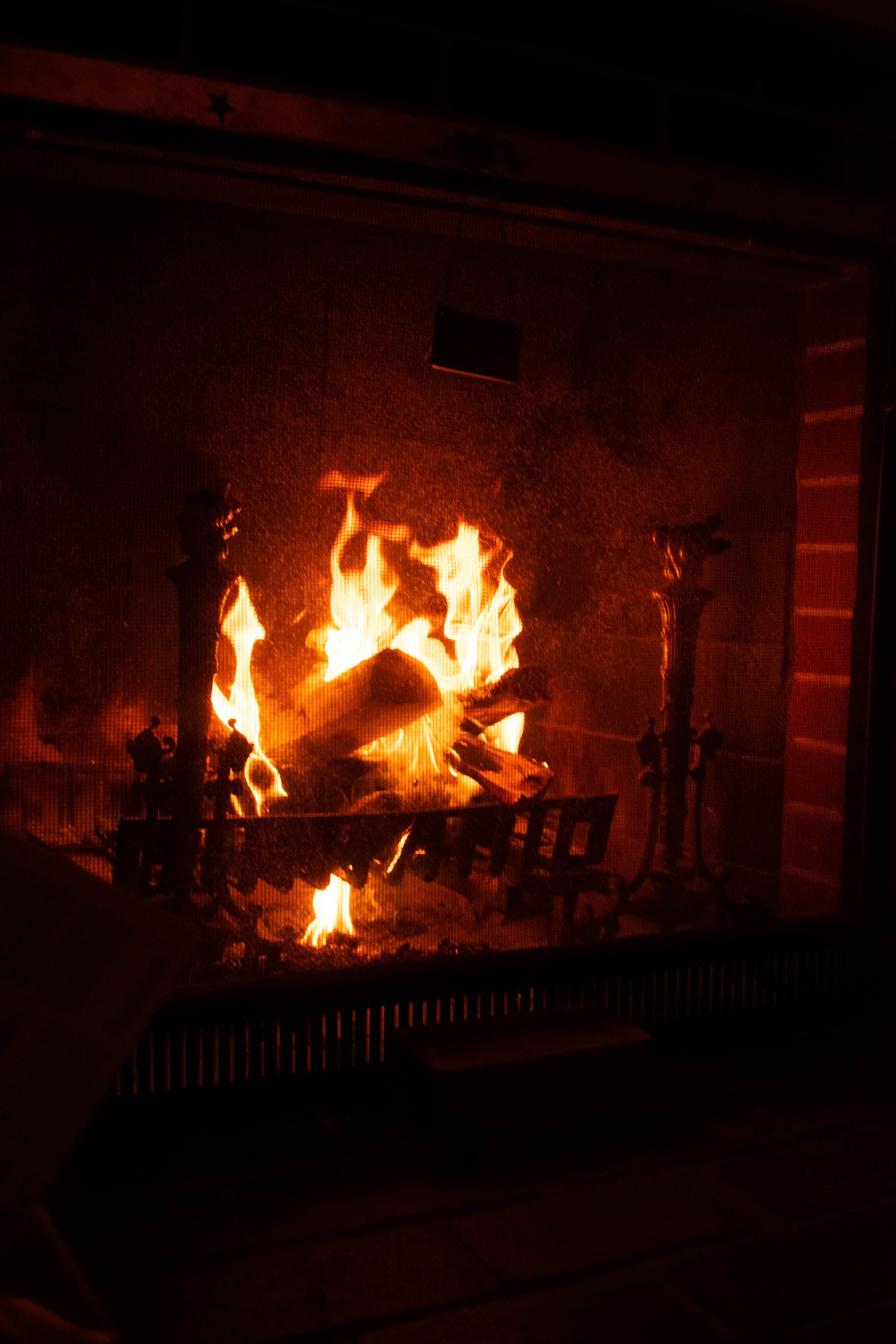 Dark fireplace interior showing flue and brick