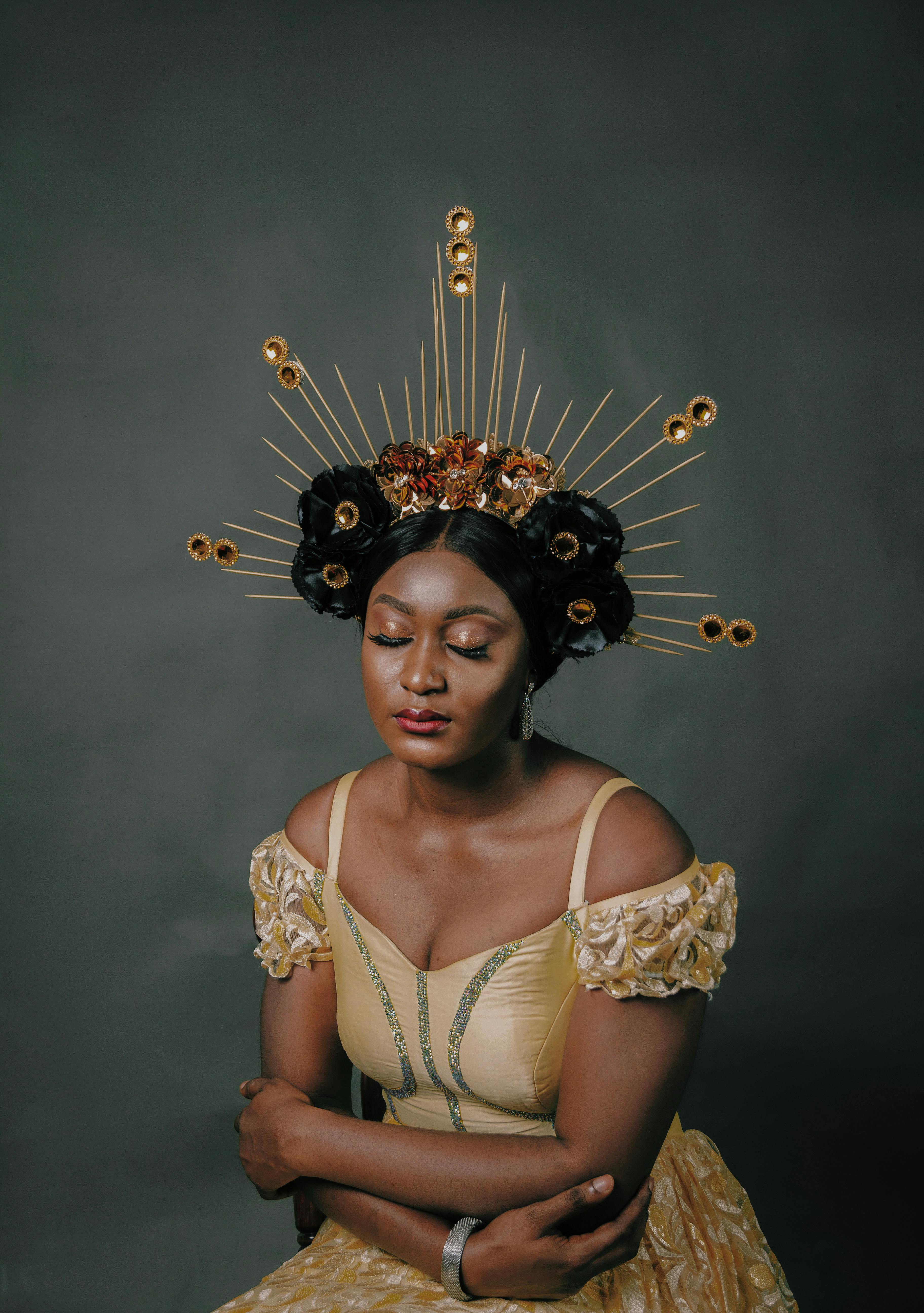 a woman wearing golden dress and crown