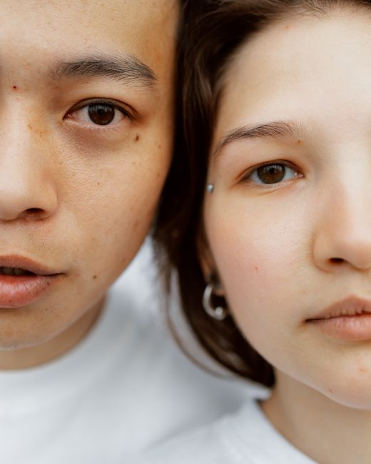Intimate close-up portrait of a diverse couple showing connection.