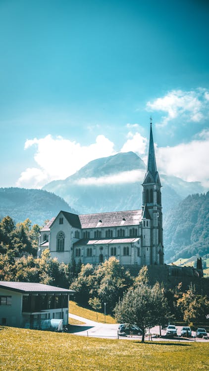 Blue Toned Image of a Church and Mountains