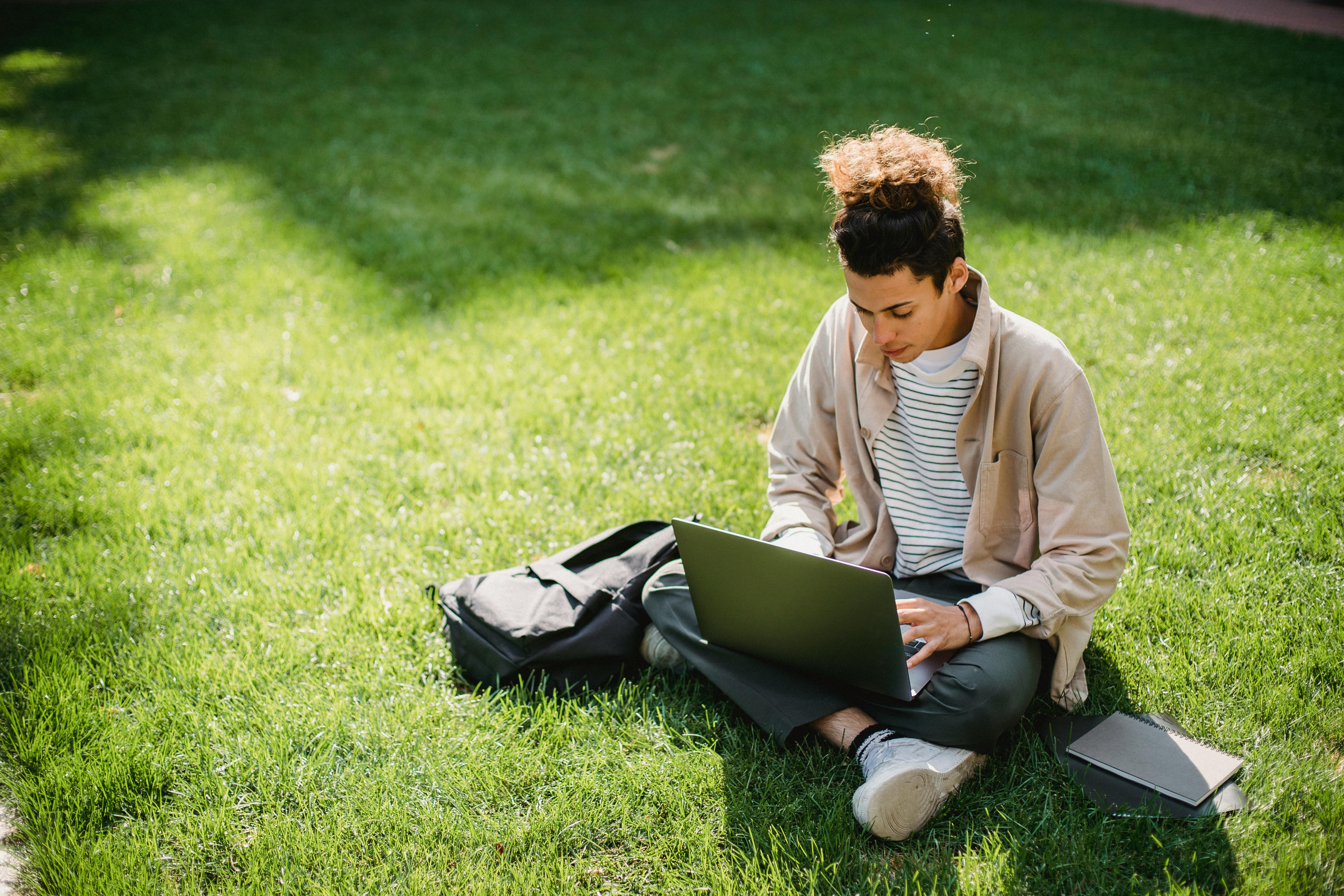 serious student typing on laptop keyboard during studies