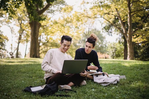 Free Men Sitting at the Park while Having Conversation Stock Photo