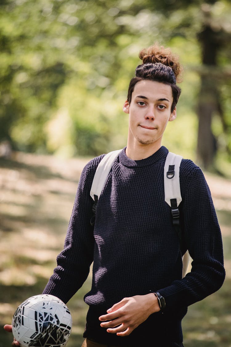 Young Ethnic Man With Soccer Ball In Park