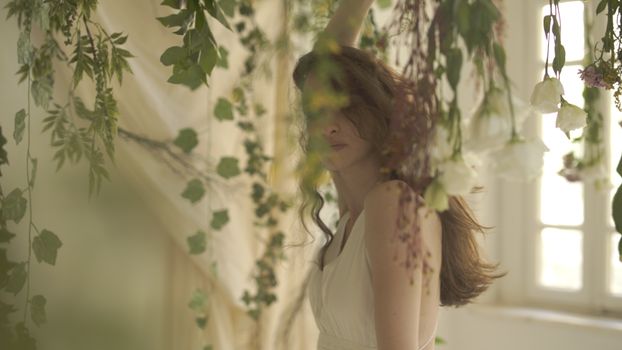 A serene portrait of a woman surrounded by lush floral decor in an Istanbul setting.