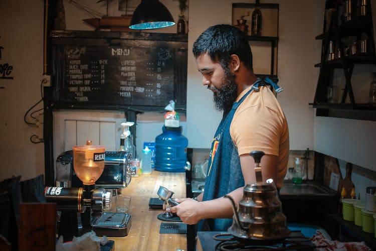 Portrait Of Barista With Coffee Maker