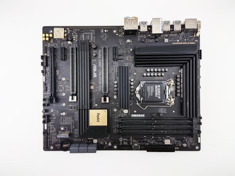 Flat lay image showcasing an ASUS Z490 motherboard with its components on a white background.